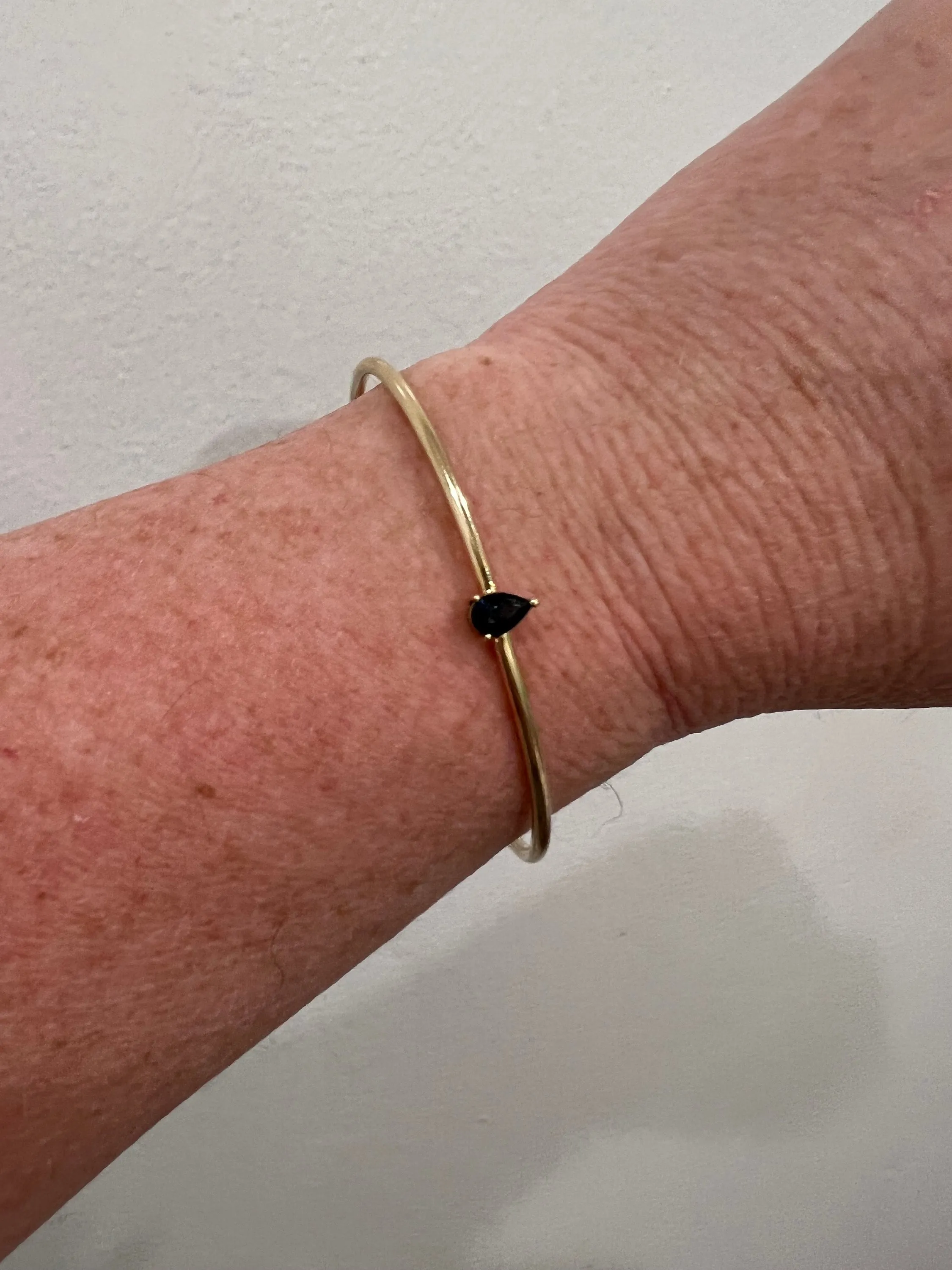 Simple Modern 14K Yellow Gold Flexible Sapphire Bangle Bracelet.